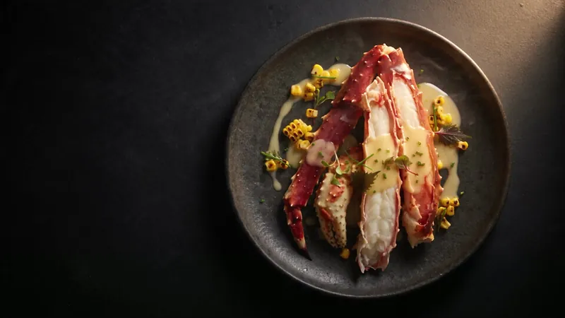 King crab plated on dark stoneware, from the Fortu build