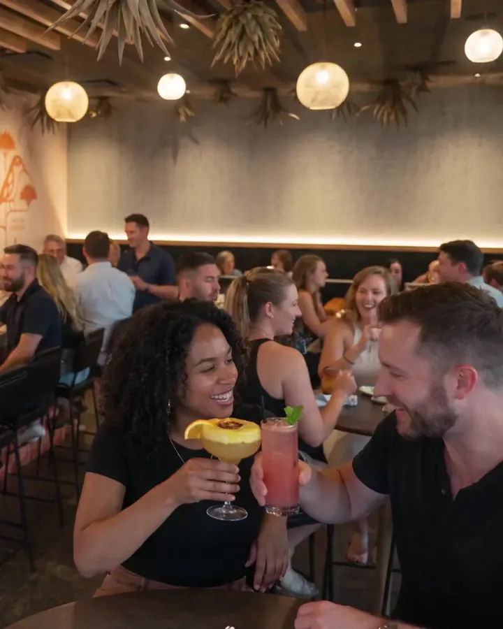 A full bar at Agave Social, friends laughing over margaritas